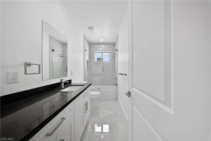 Bathroom with vanity and  shower combination