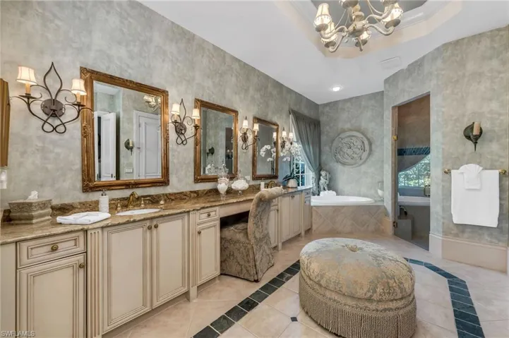 Large bath with double vanity, makeup area and separate water closet with bidet.