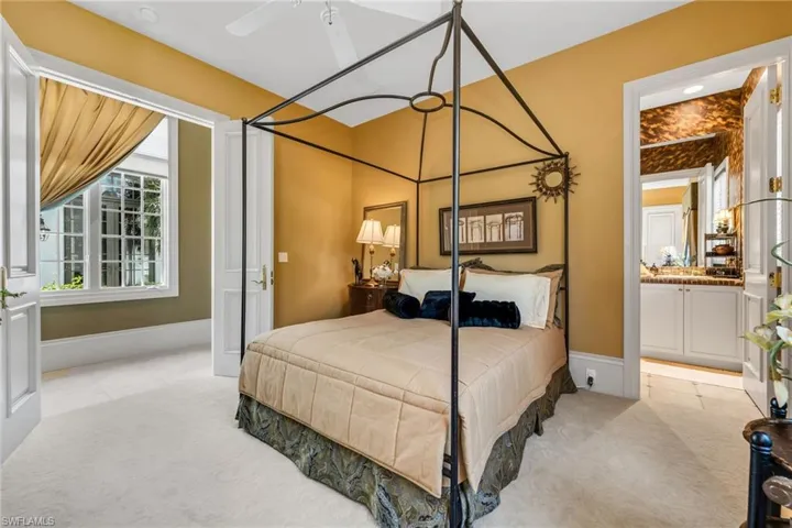 Guest Bedroom with double French doors to the hallway, large, walk-in closet and ensuite bath.