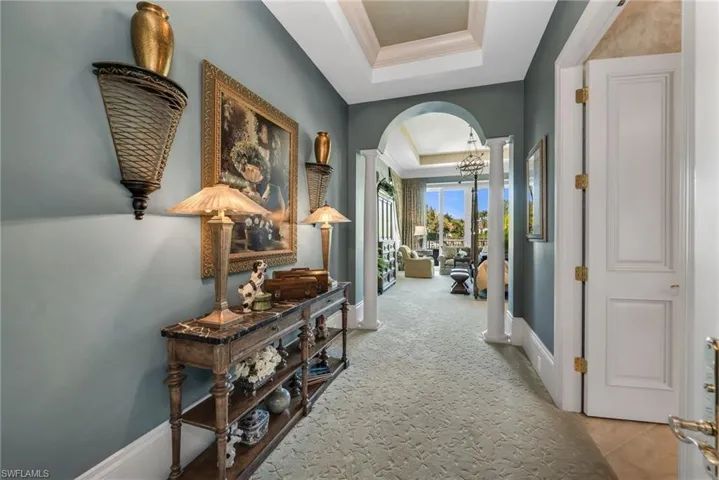 The entry to the Owner's Suite has a large hallway with double French doors at the entryway.