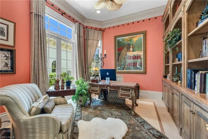 Office with French doors leading to an interior courtyard with fountain.