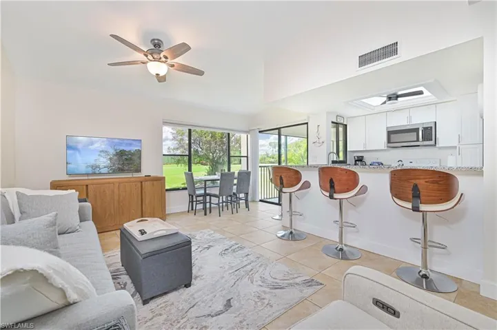 Living room featuring ceiling fan and light tile patterned flooring
