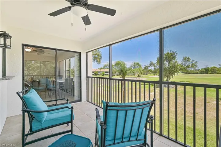 Sunroom featuring a ceiling fan, golf course view, and a balcony