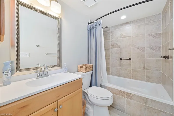 Full bathroom featuring vanity, recessed lighting, tiled shower / bath, and light tile patterned floors
