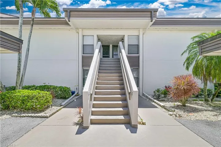 Doorway to property featuring stucco siding
