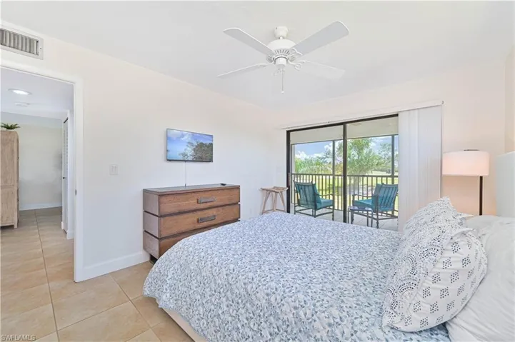 Bedroom with access to exterior, ceiling fan, and light tile patterned floors