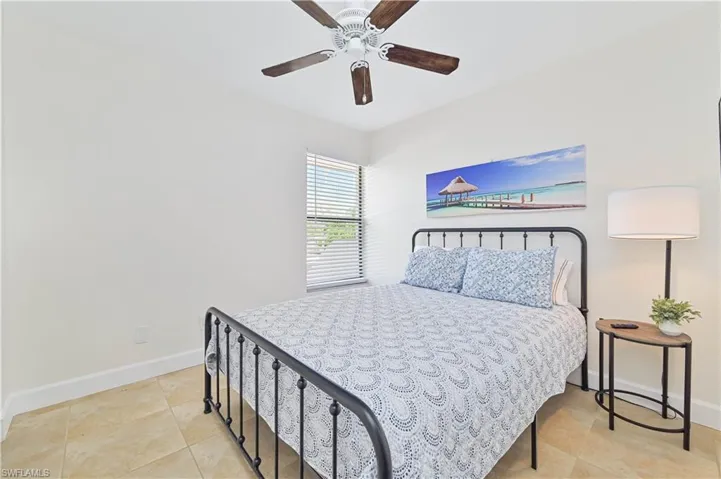 Bedroom featuring a ceiling fan and light tile patterned floors
