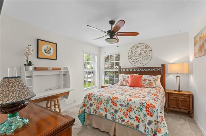 Guest Bedroom featuring light colored carpet, ceiling fan.