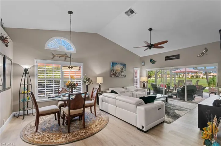 Spectacular view!!!Living area with high vaulted ceiling, visible vents, plenty of natural light, and light wood finished floors