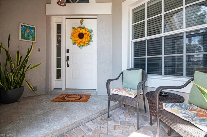 Doorway to property with visible vents and stucco siding