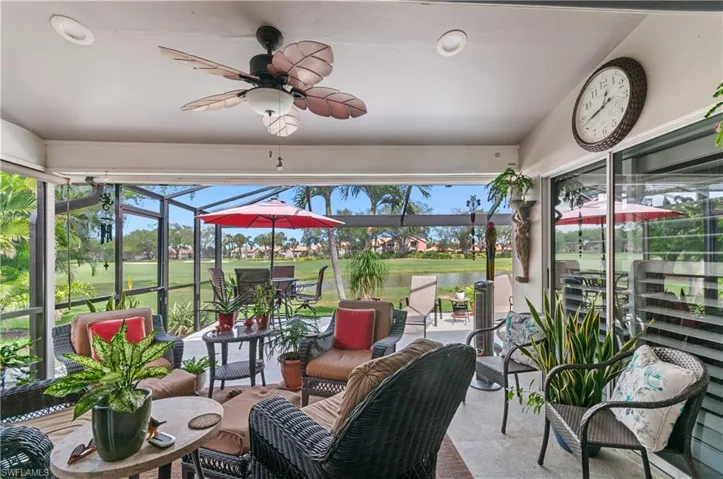 Covered lanai featuring ceiling fan and gorgeous view of lake and golf course.