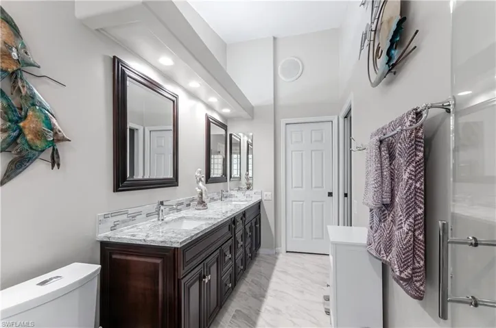 Master bathroom beautifully updated featuring soft close cabinets, tile floor, and double sinks.