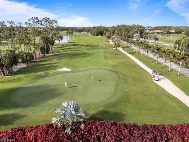 View of community featuring view of golf course and a lawn