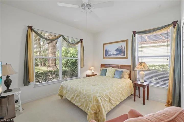 Bedroom with carpet, ceiling fan, and baseboards