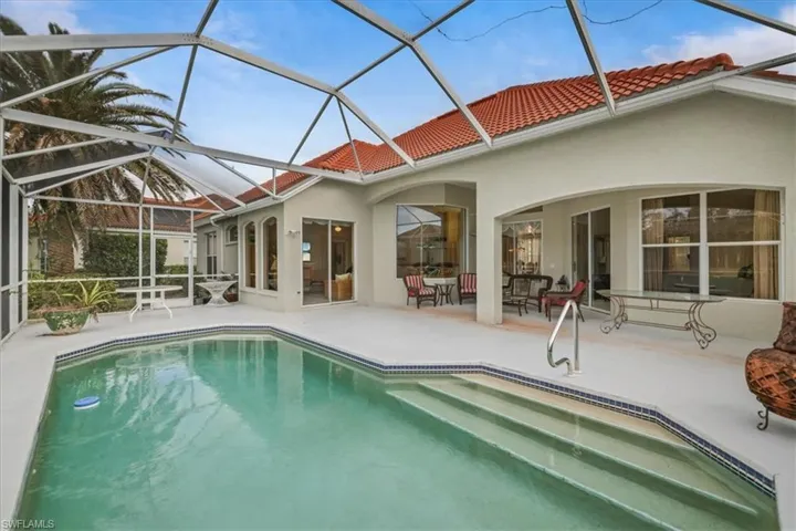 Outdoor pool featuring a lanai and a patio area