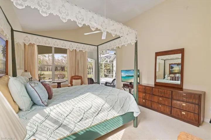 Carpeted bedroom featuring access to exterior and vaulted ceiling