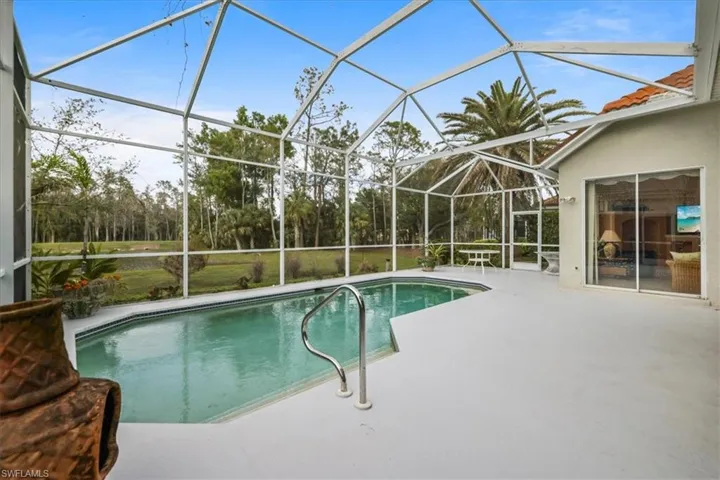 Outdoor pool with glass enclosure and a patio
