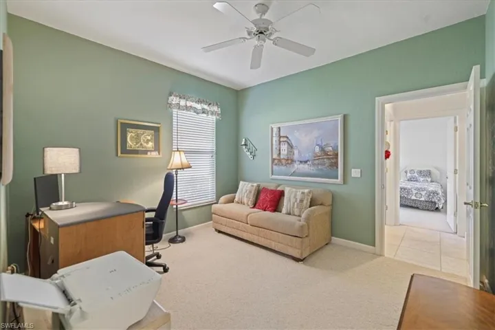 Office with carpet floors, a ceiling fan, and baseboards