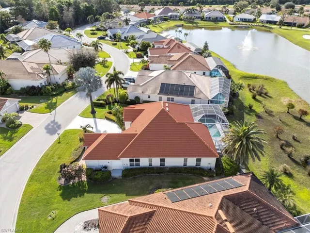 Birds eye view of property featuring a water view and a residential view