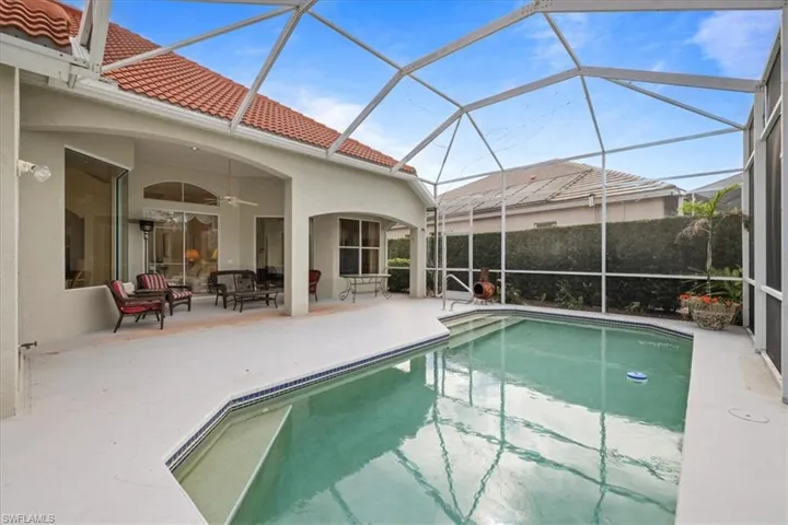 View of pool with ceiling fan, a patio area, a lanai, and a fenced in pool