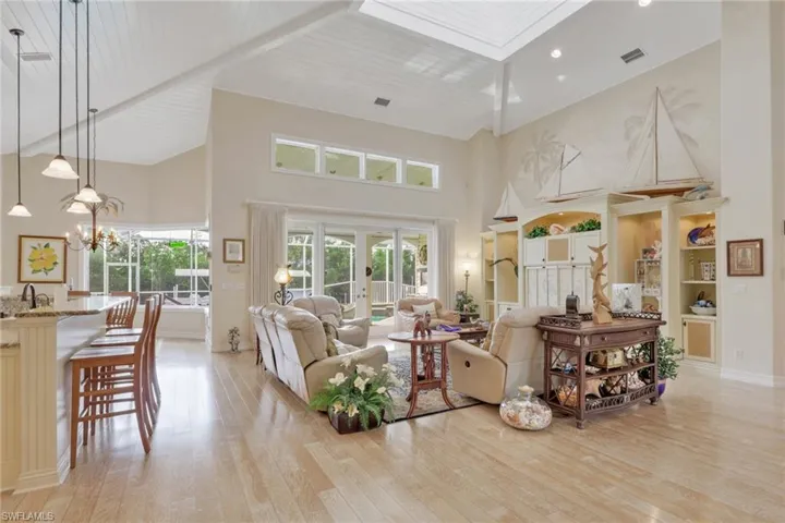 Main living area with soaring ceilings and adjoining kitchen.