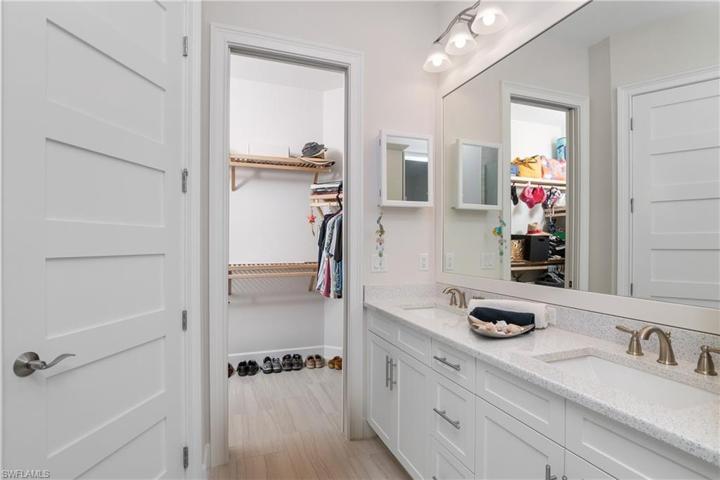 Dual Master Sinks, Quartz Counters with White Cabinetry that matches throughout the house. Walk in Closet.
