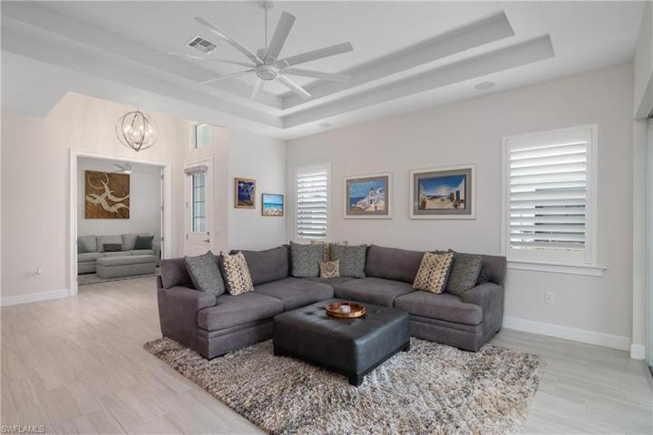 Great Room Views, note the Tile Flooring, Fixtures, Plantation Shutters, Entry Door and Den.