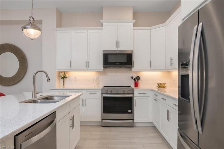 Attractive Tile Flooring, Quartz Tops, White Cabinets, Stainless Appliances.