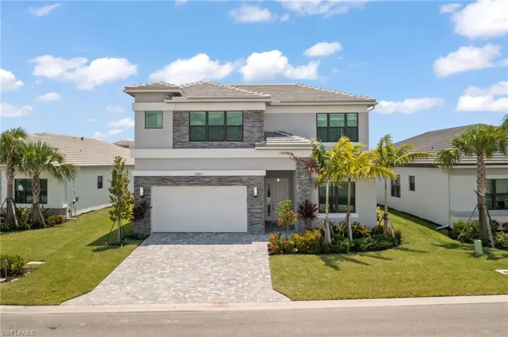 View of front of home featuring a garage and a front yard