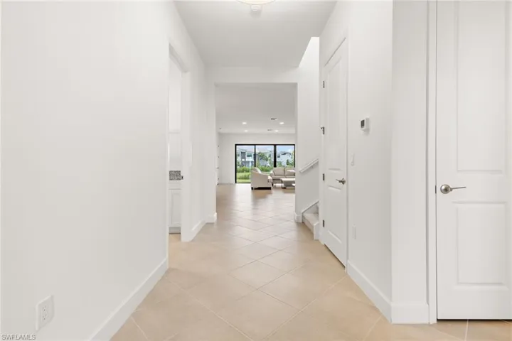 Corridor with light tile patterned flooring