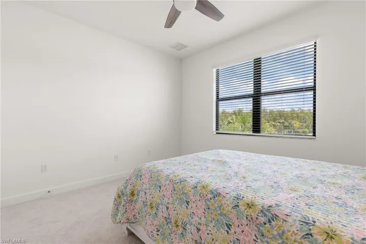 Bedroom featuring ceiling fan and carpet