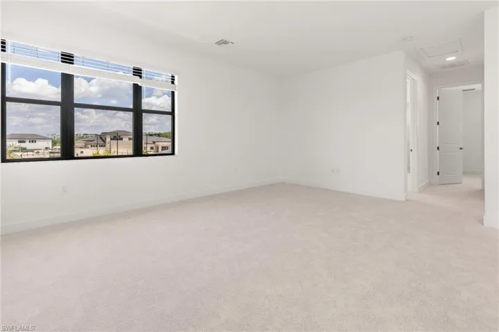 Spare room with light colored carpet