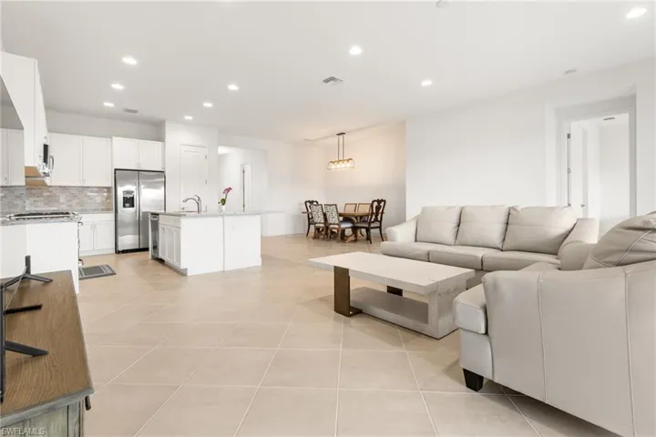 Living room featuring sink and light tile patterned floors
