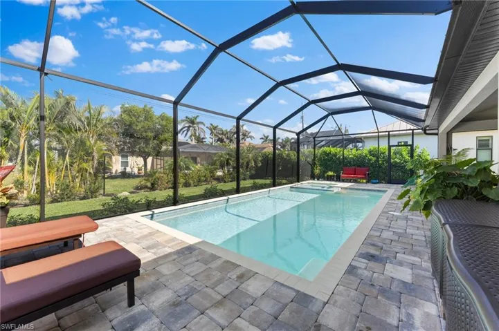 View of pool with a patio and screen enclosure