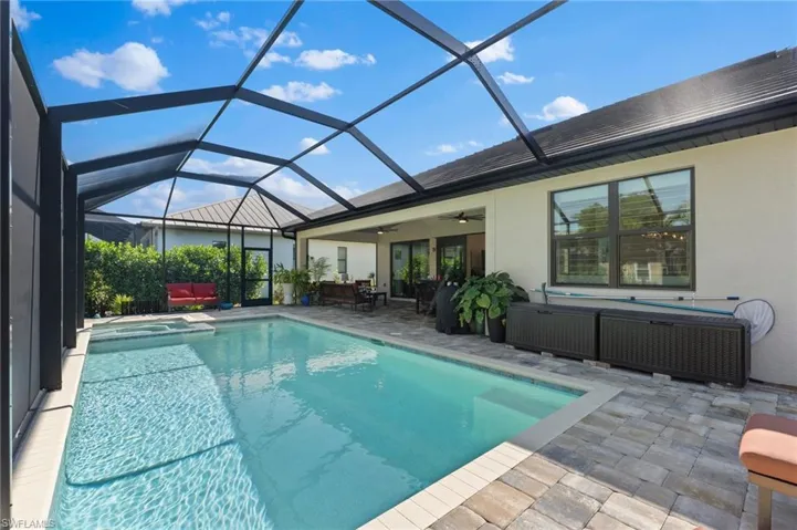 View of swimming pool featuring, ceiling fans, an outdoor hangout area, and a lanai