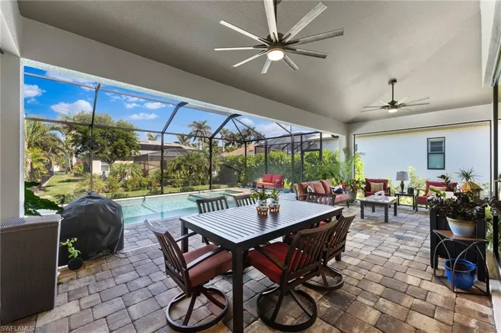 Lanai with outdoor lounge area, area for grilling, ceiling fan.