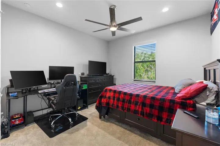Bedroom with light colored carpet and ceiling fan