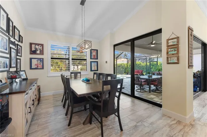 Dining room featuring lofted ceiling and crown molding
