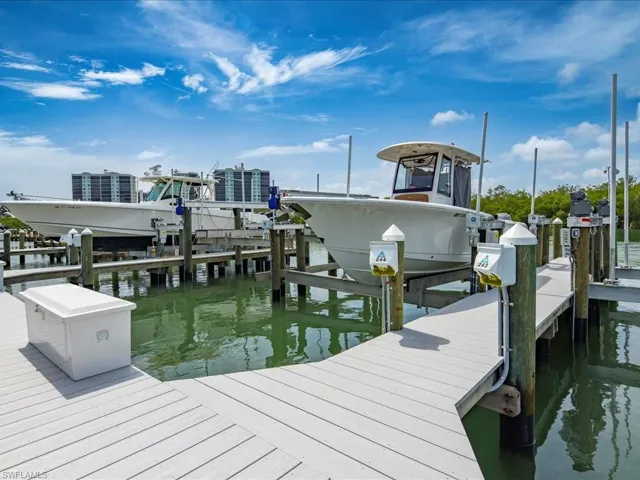 Dock featuring boat lift and a water view