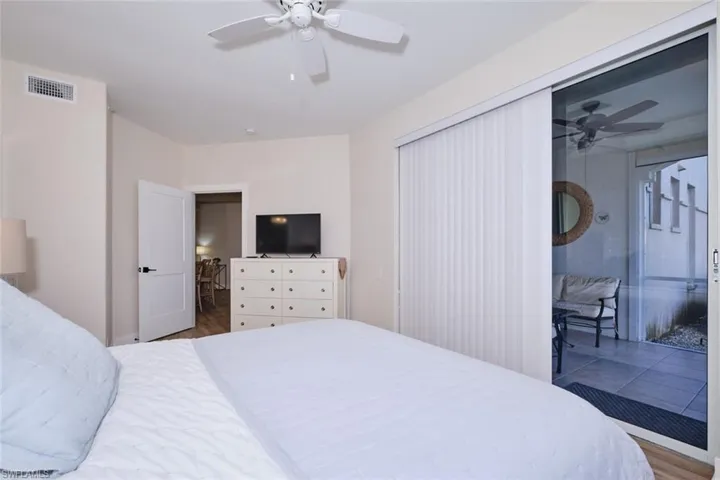 Bedroom featuring ceiling fan and dark hardwood / wood-style flooring
