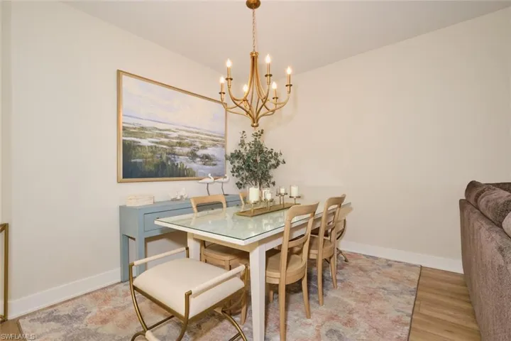 Dining area featuring an inviting chandelier and hardwood / wood-style flooring