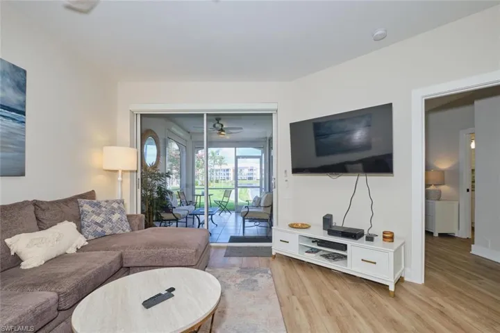 Living room featuring ceiling fan and light hardwood / wood-style flooring