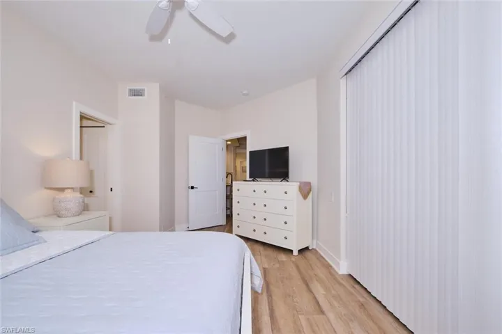 Bedroom featuring light hardwood / wood-style floors, a closet, and ceiling fan