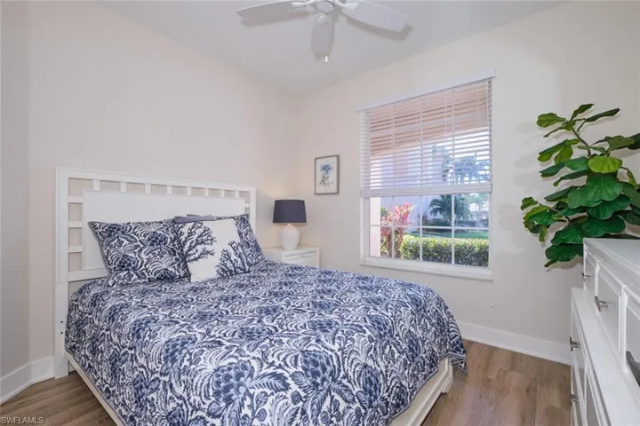 Bedroom with hardwood / wood-style floors and ceiling fan