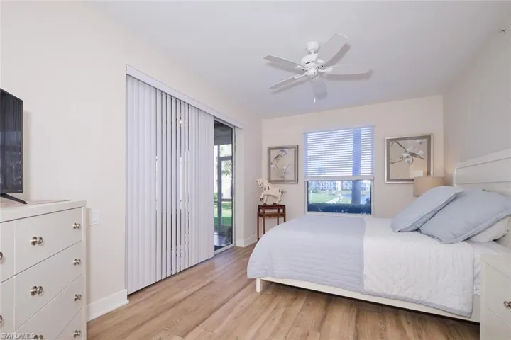 Bedroom featuring access to outside, ceiling fan, and light hardwood / wood-style flooring