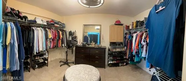 Walk in closet featuring lofted ceiling
