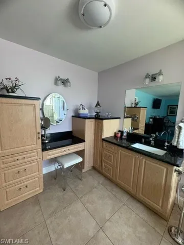 Bathroom with tile patterned flooring and sink
