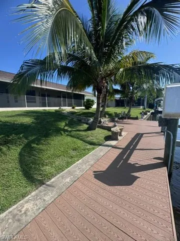 View of home's community with a lawn