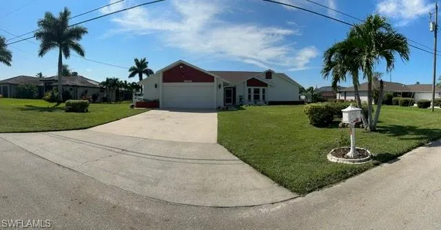 Ranch-style house with a garage and a front yard