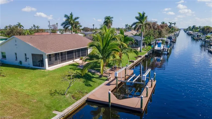 View of dock featuring a water view and a lawn
